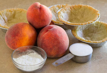 Ingredients for peach tart; peaches, tart shell, sugar, cornstarch.