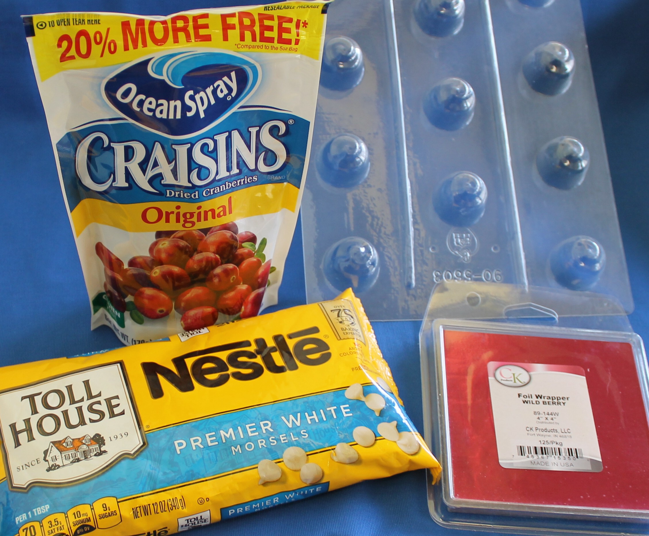 Dried cranberries, (Craisins), Nestle white chocolate morsels, candy mold, foil wrappers