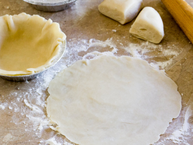 5-inch Tart pan lined with piece of dough.