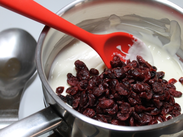 Dried cranberries added to melted white morsels.