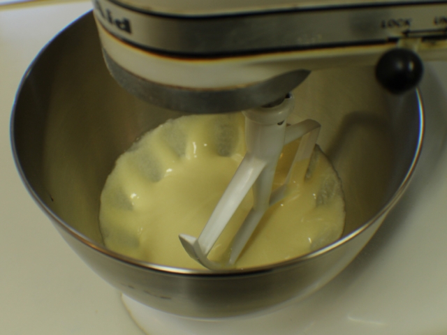Combine egg yolks and sugar in mixer, beat well