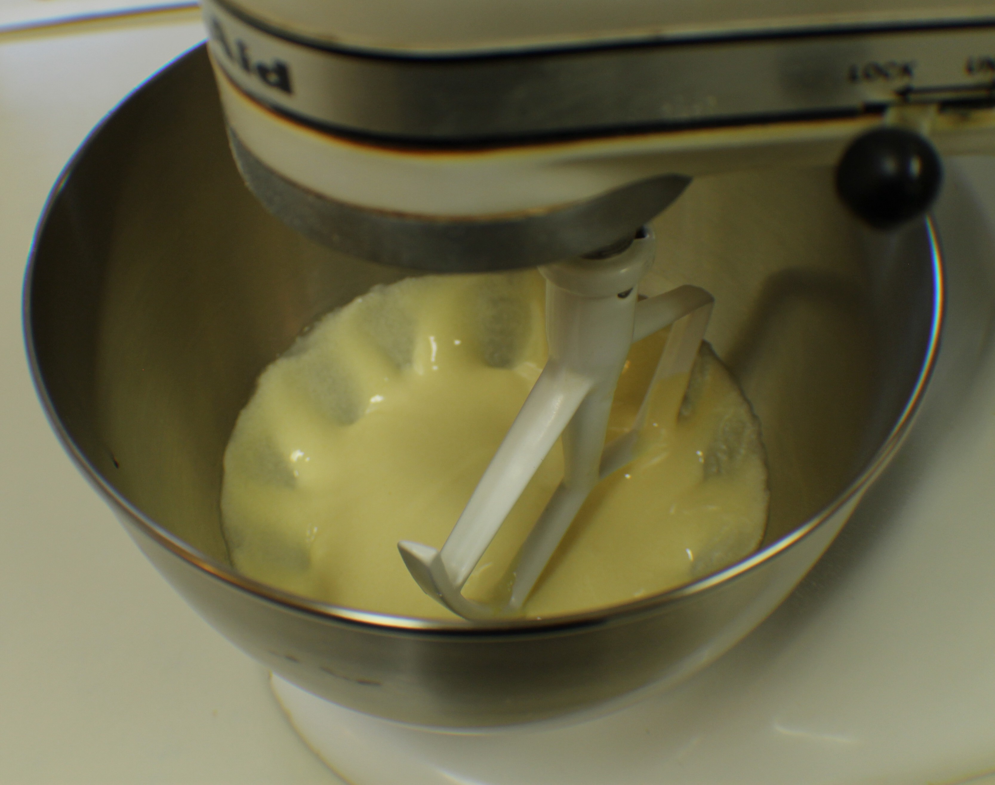 Combine egg yolks and sugar in mixer, beat well