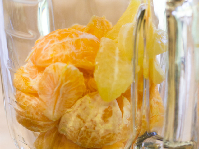 Lemon and tangerine fruit in a blender.
