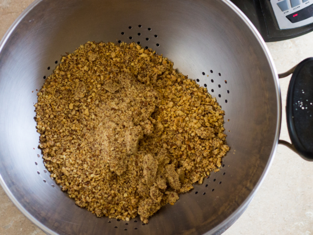Ground almonds in colander over bowl