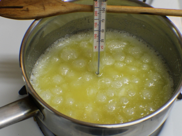 Butter and sugar mixture boiling in saucepan.