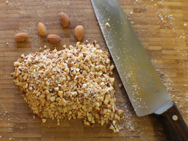 Coarse chopped almonds with knife.