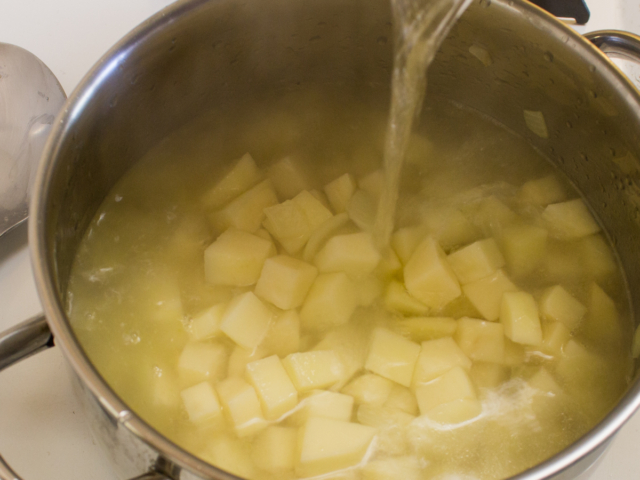Potatoes and hot water added to pot.