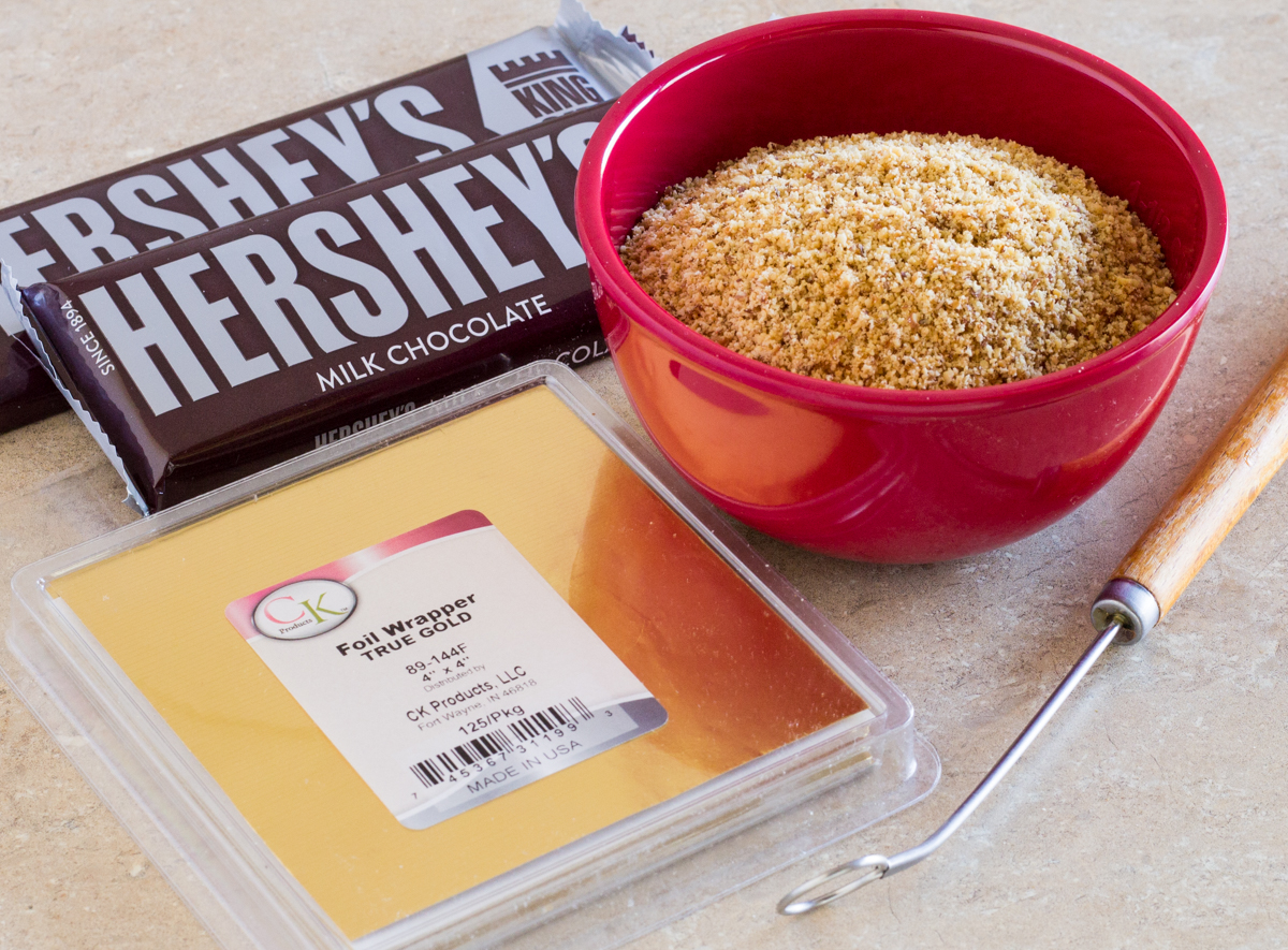 chocolate, finely chopped almonds. dipping tool, gold foil wrappers
