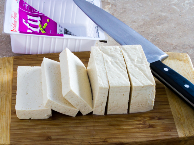 Slicing fresh tofu into eight pieces
