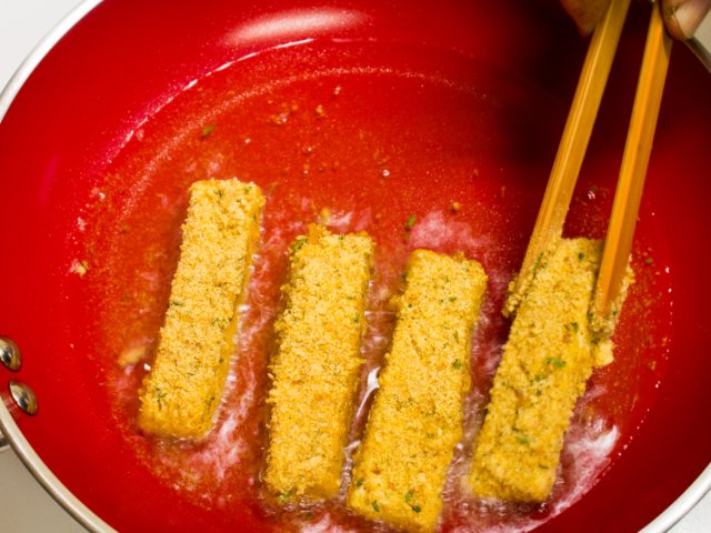 Tofu fish sticks in frying pan with oil