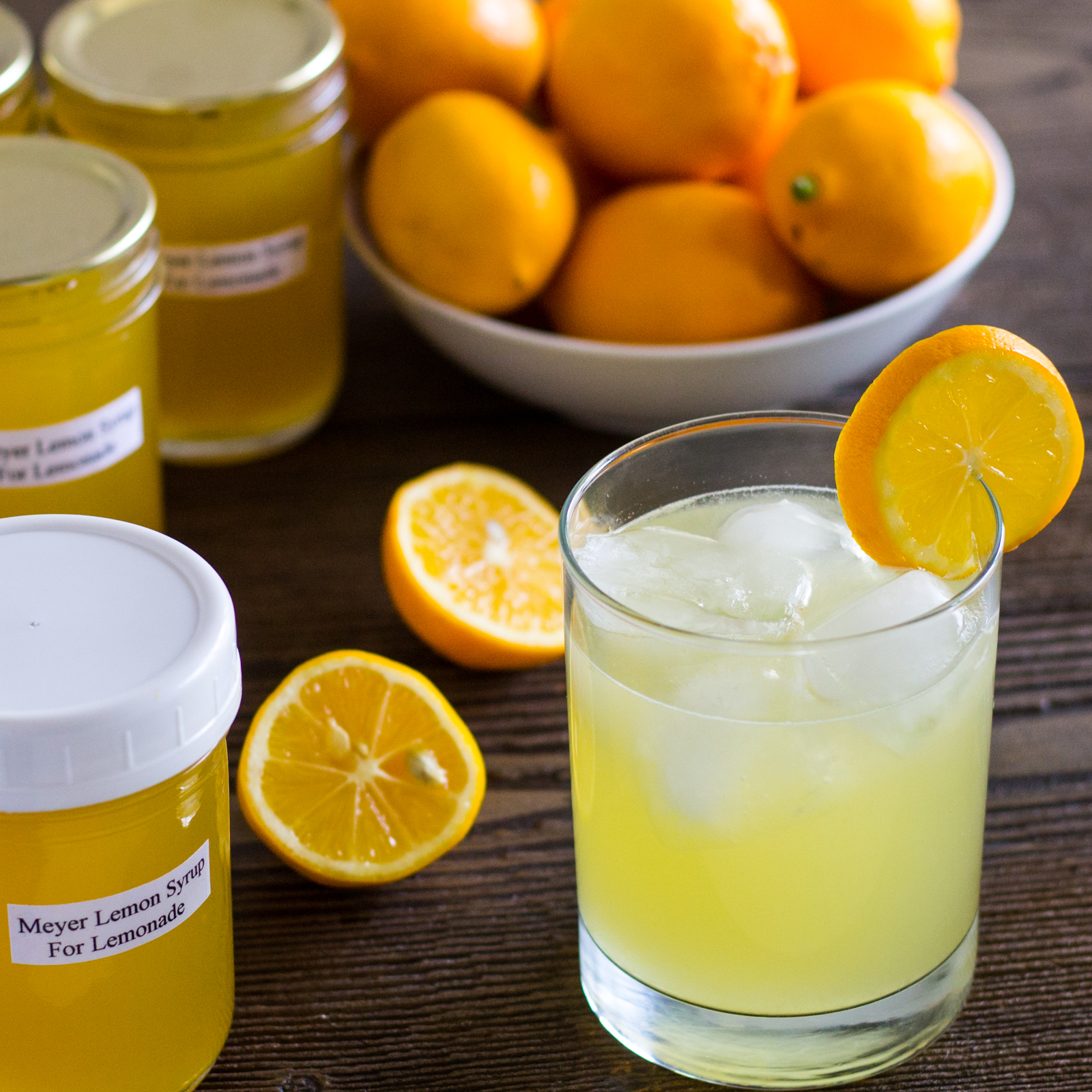 Glass and jars of lemonade