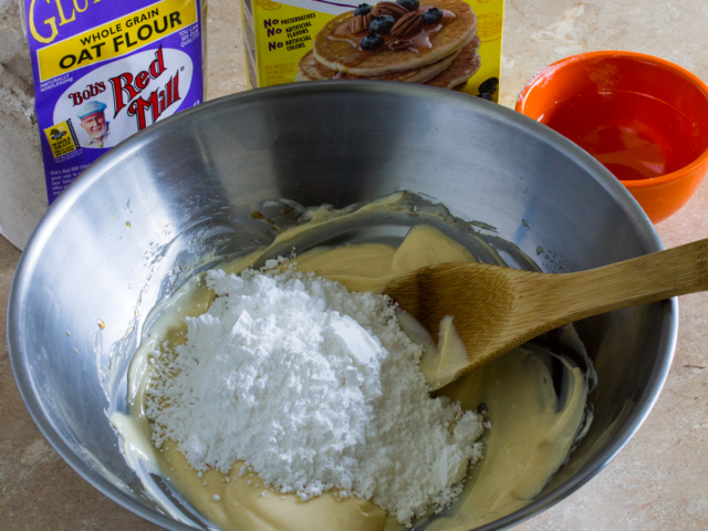 Add the powdered sugar to the butter in the bowl.