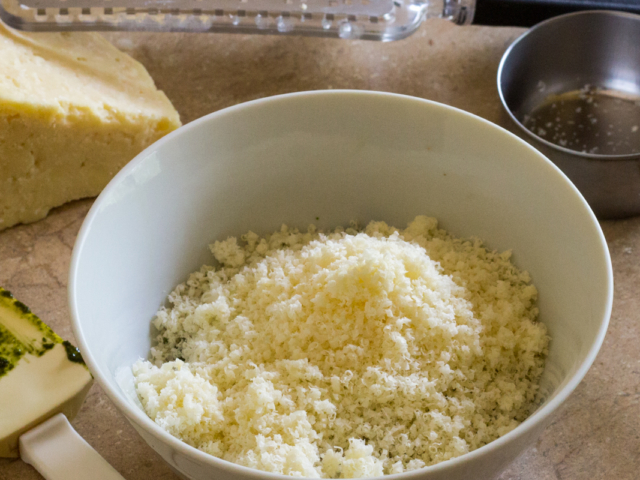 Grated Parmesan added to bowl.