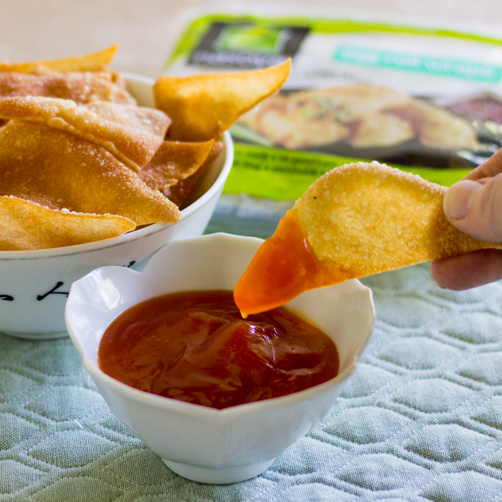 Bowl of fried egg roll chips with sweet and sour dipping sauce