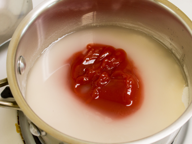 Ketchup water white vinegar and peanut oil added to saucepan.