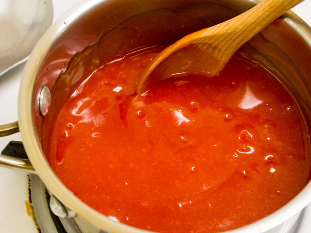 Thickened sweet and sour sauce in saucepan.