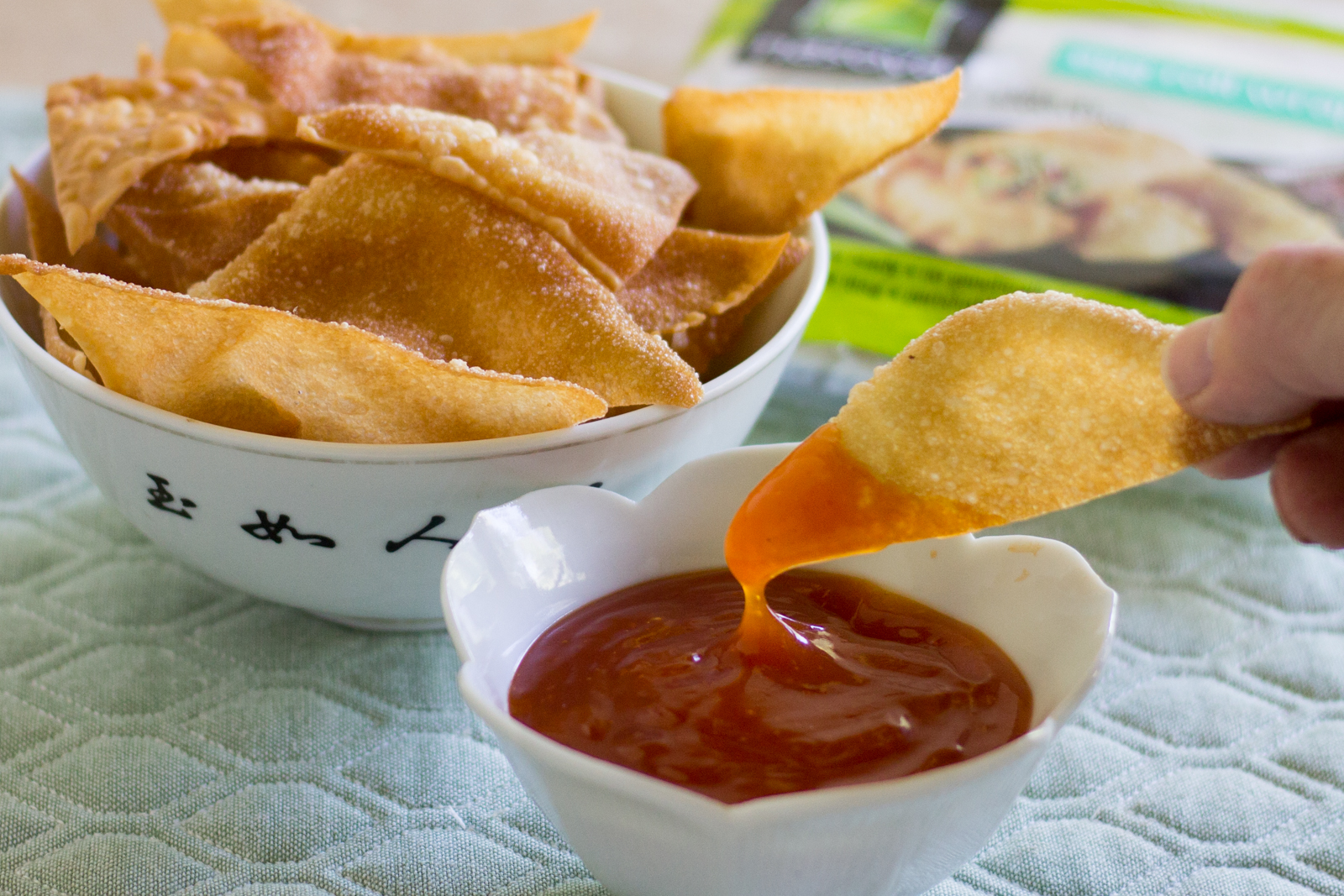 Bowl of egg roll chips with sweet and sour dipping sauce.