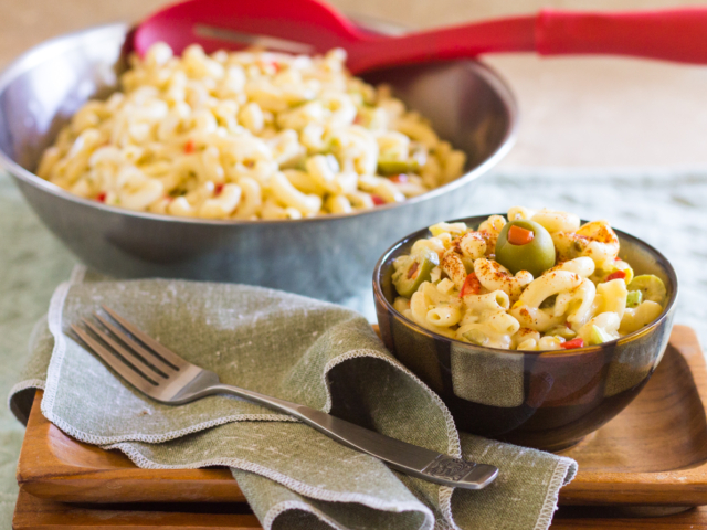 Refrigerate macaroni salad. Serve topped with paprika and Spanish olive.