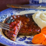Seitan Vegan Steak with Honey Barbecue Sauce mashed potatoes and carrots.