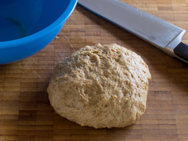 Kneaded ball of seaitan dough on a cutting board.