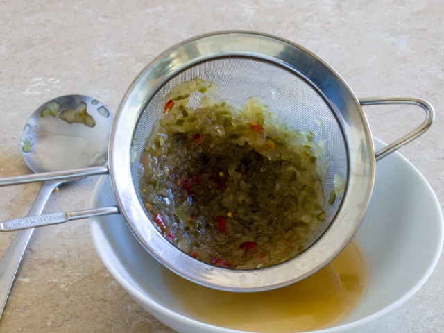 Relish in strainer after being pressed with back of soup spoon to remove syrup.