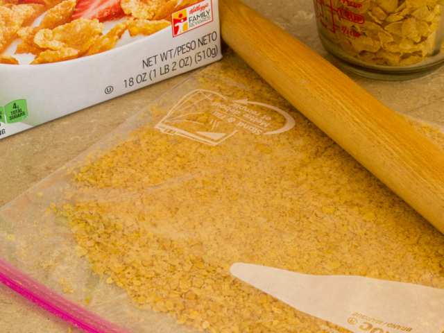 Finished bag of corn flake crumbs with rolling pin.