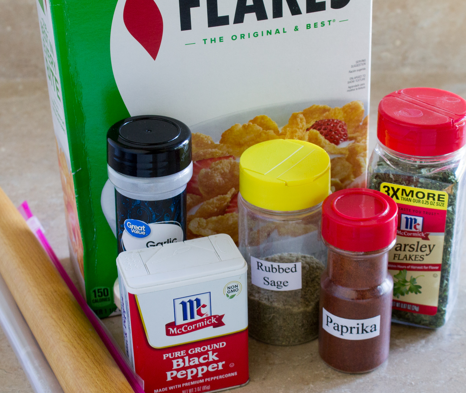 Ingredients - box of corn flakes, garlic salt, rubbed sage, dried parsley flakes, black pepper, and paprika